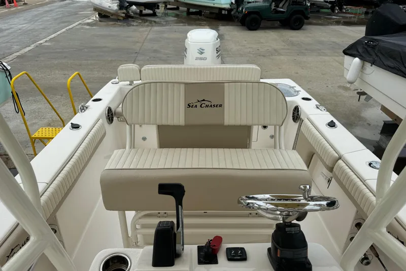 Slide: The Image of 2019 Sea Chaser 24 HFC boat interior with steering wheel and seating. - 9