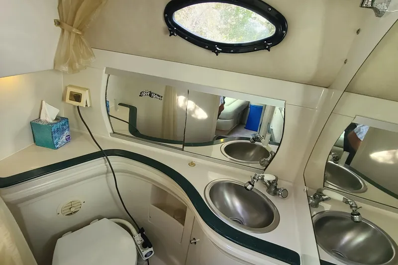 Slide: The Image of Bathroom interior of 1996 Regal Commodore 292 boat with sink and mirror. - 14