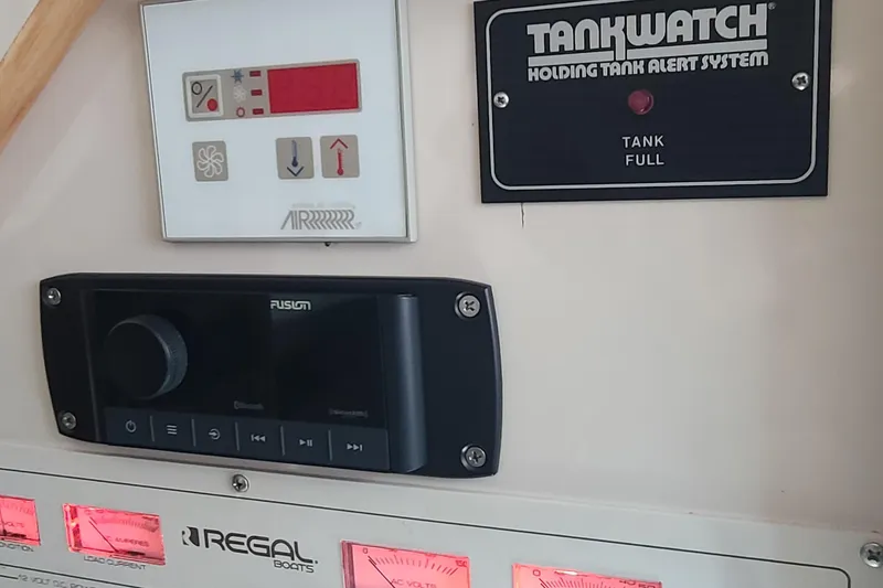 Slide: The Image of Control panel of a 1996 Regal Commodore 292 boat with tank alert system. - 18