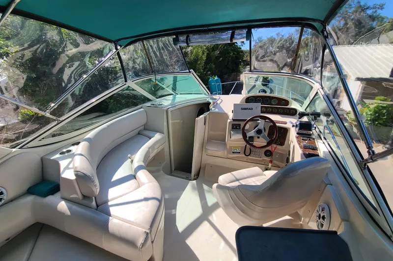 Slide: The Image of Interior of a 1996 Regal Commodore 292 boat with seating and control panel. - 19