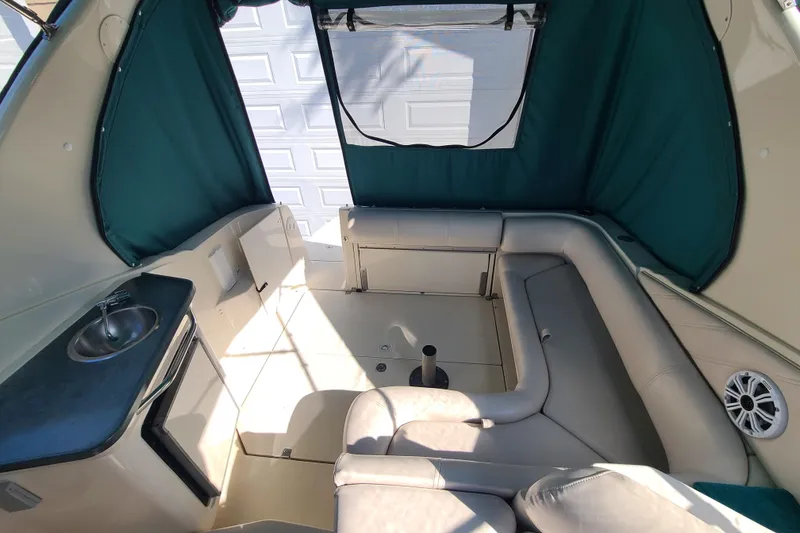 Slide: The Image of Interior of a 1996 Regal Commodore 292 boat with seating and kitchenette. - 23