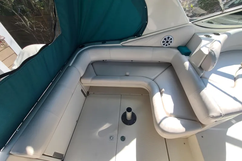 Slide: The Image of 1996 Regal Commodore 292 boat interior with white seating and teal canopy. - 24
