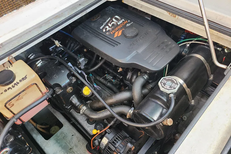 Slide: The Image of Engine compartment of a 1996 Regal Commodore 292 boat, featuring a MerCruiser 350 MPI Horizon. - 26