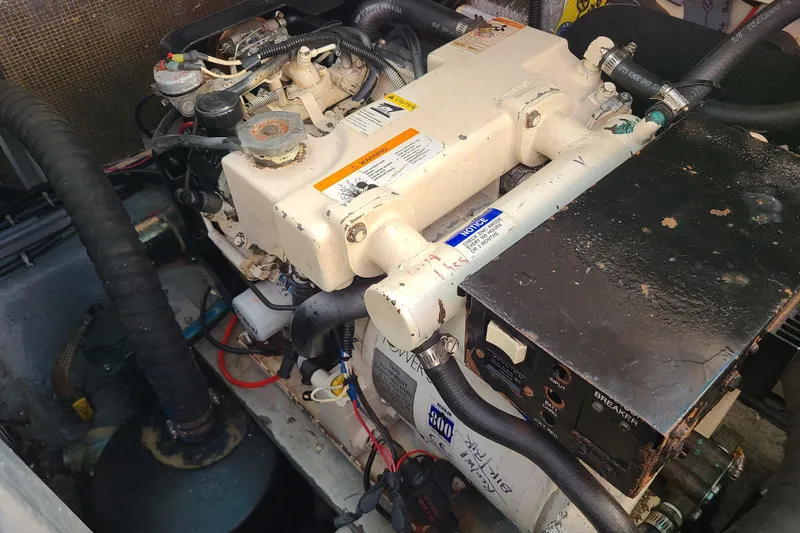 Slide: The Image of Engine compartment of a 1996 Regal Commodore 292 boat, showing mechanical components and wiring. - 28