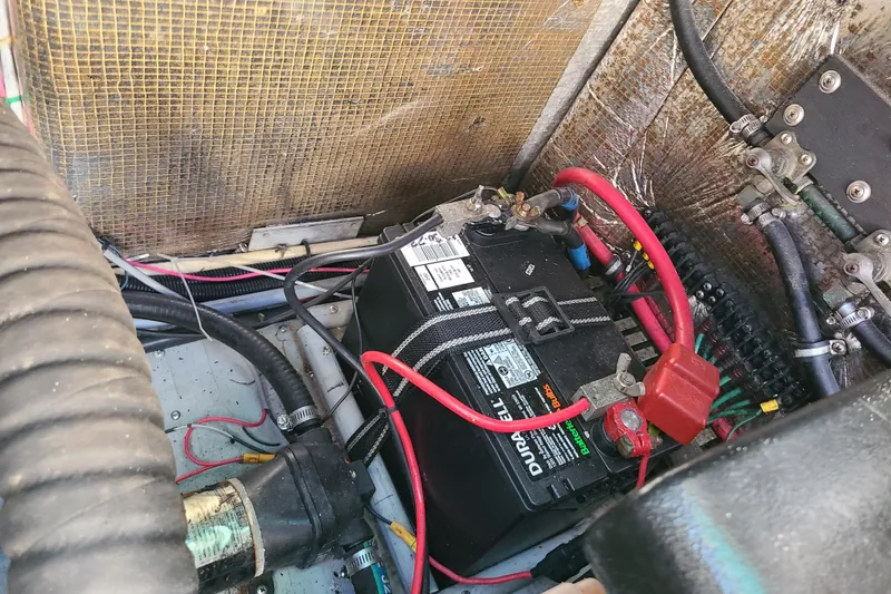 Slide: The Image of Battery compartment of a 1996 Regal Commodore 292 boat with wiring and connections. - 29