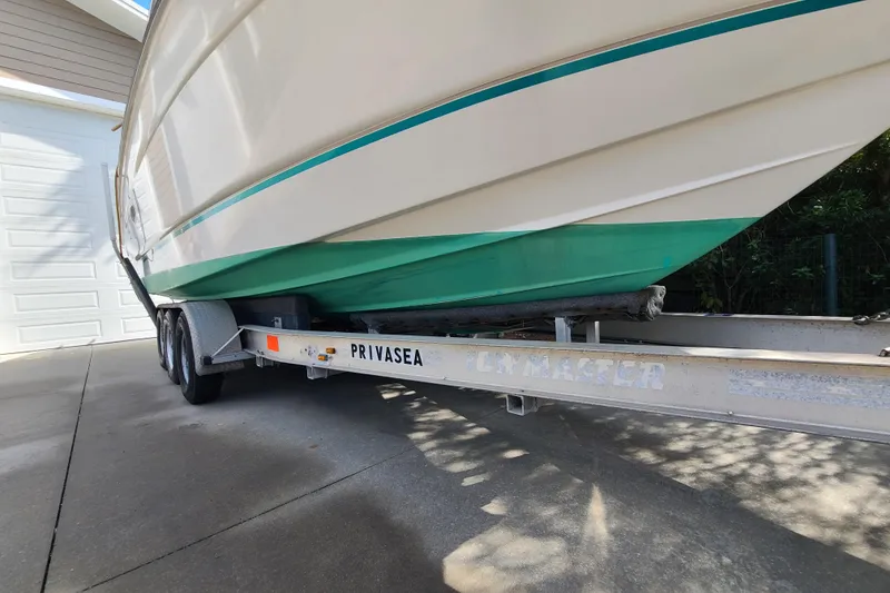 Slide: The Image of 1996 Regal Commodore 292 boat on trailer, parked in driveway. - 3