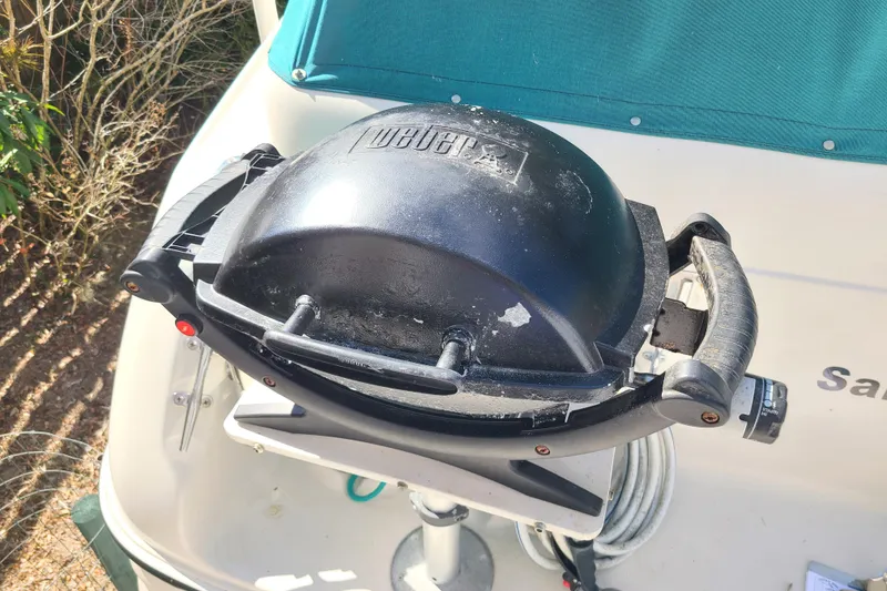 Slide: The Image of Weber grill on 1996 Regal Commodore 292 boat deck, sunny day. - 33