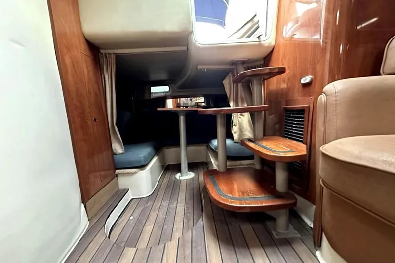 Slide: The Image of 2006 Four Winns 348 Vista yacht docked in a marina with cityscape background. - 10