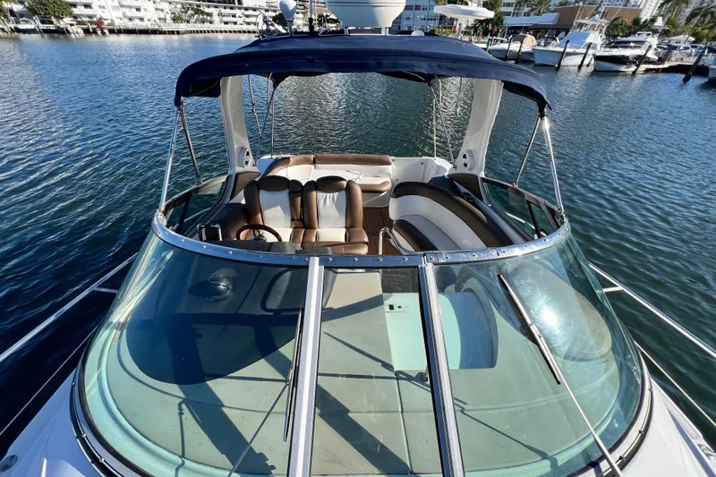 Slide: The Image of 2006 Four Winns 348 Vista boat with spacious seating, docked in a marina. - 101