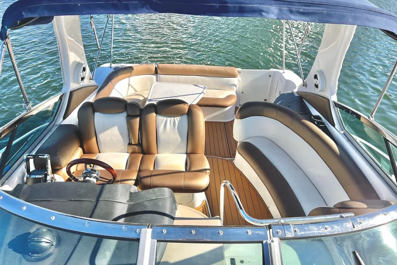 Slide: The Image of 2006 Four Winns 348 Vista boat interior with luxurious seating and wooden flooring. - 102