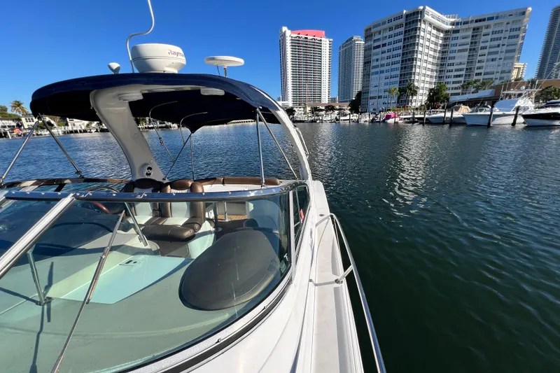 Slide: The Image of 2006 Four Winns 348 Vista yacht docked near modern waterfront buildings. - 103