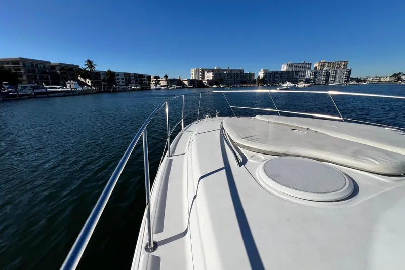 Slide: The Image of 2006 Four Winns 348 Vista yacht cruising in a sunny marina with cityscape views. - 105