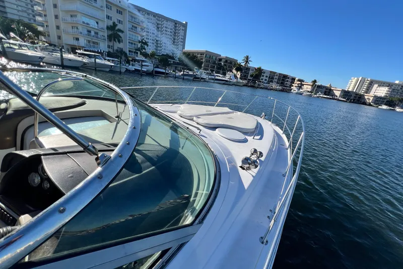 Slide: The Image of 2006 Four Winns 348 Vista yacht docked in a marina with waterfront buildings. - 109