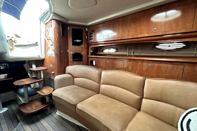 Slide: The Image of 2006 Four Winns 348 Vista yacht on calm water with cityscape background. - 11