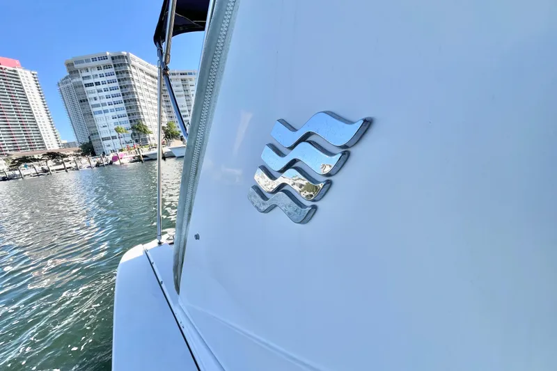 Slide: The Image of 2006 Four Winns 348 Vista boat docked near waterfront buildings. - 110