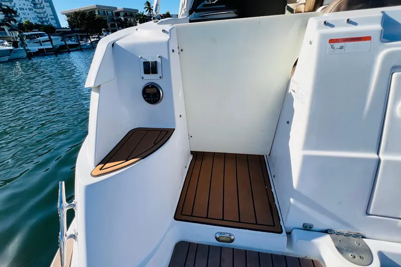 Slide: The Image of 2006 Four Winns 348 Vista boat deck with wood accents, docked in marina. - 114