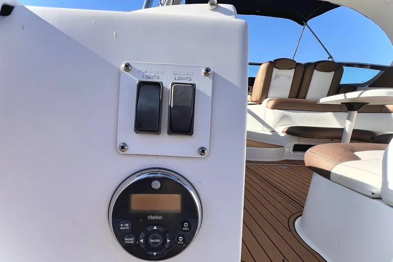 Slide: The Image of 2006 Four Winns 348 Vista boat interior with light switches and audio controls. - 116