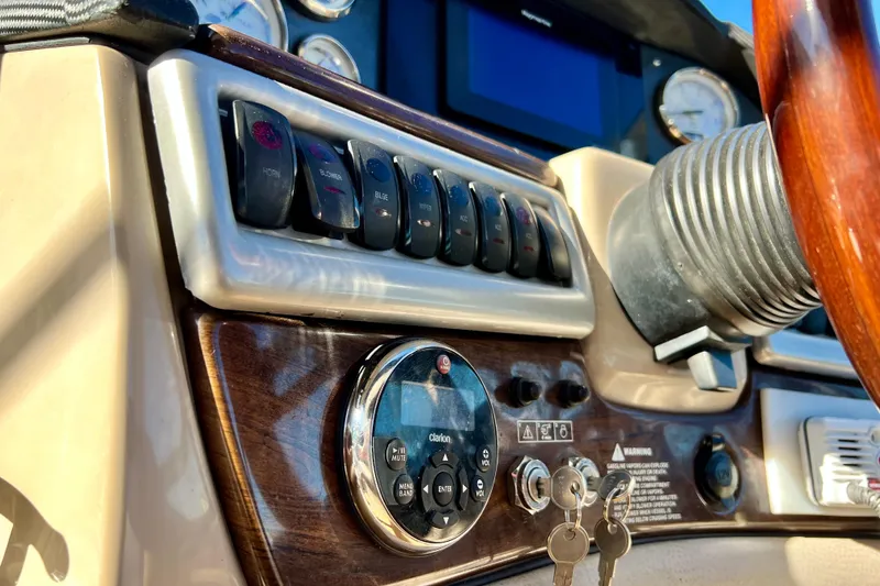 Slide: The Image of 2006 Four Winns 348 Vista boat dashboard with controls and steering wheel. - 119