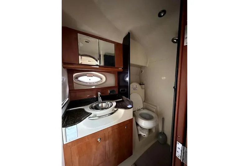 Slide: The Image of 2006 Four Winns 348 Vista boat docked on calm waters near waterfront buildings. - 15