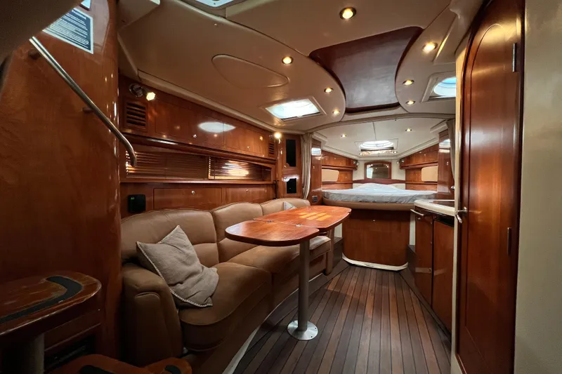 Slide: The Image of Luxurious 2006 Four Winns 348 Vista yacht interior with wood finish and cozy seating area. - 21