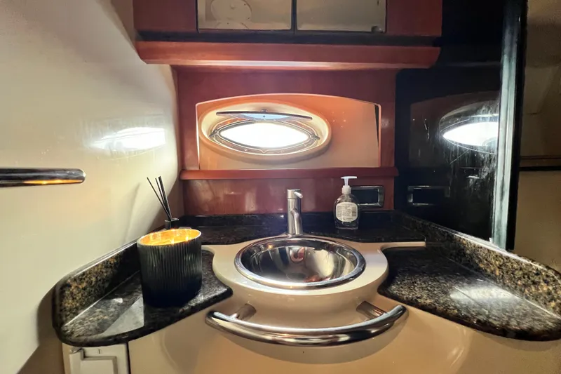 Slide: The Image of Luxurious bathroom interior of 2006 Four Winns 348 Vista yacht with sink and porthole. - 24