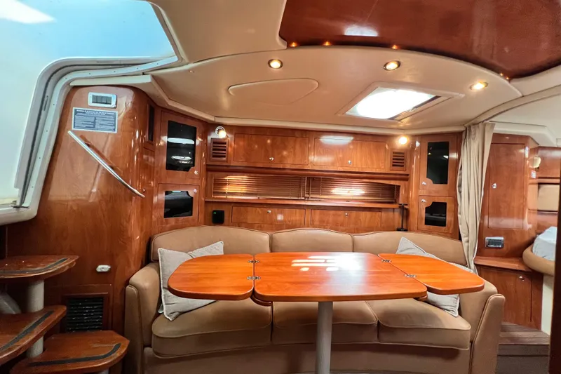 Slide: The Image of 2006 Four Winns 348 Vista yacht interior with wood finish and cozy seating area. - 29