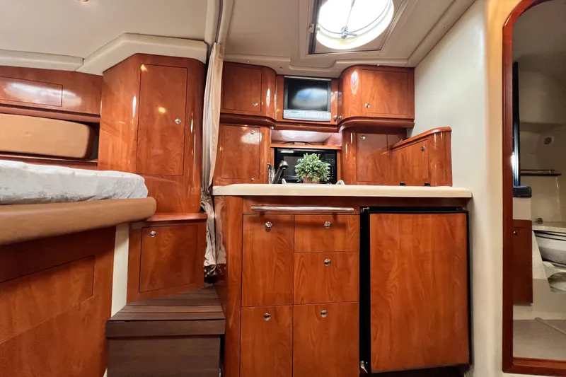 Slide: The Image of Luxurious 2006 Four Winns 348 Vista yacht interior with wood cabinetry and modern amenities. - 30