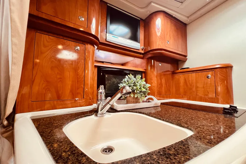 Slide: The Image of Luxurious 2006 Four Winns 348 Vista yacht interior with wood cabinetry and modern amenities. - 33
