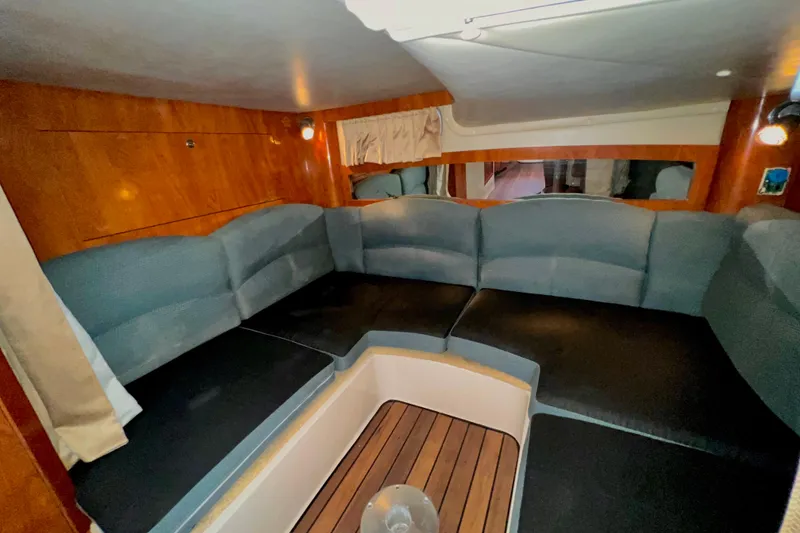 Slide: The Image of Interior of 2006 Four Winns 348 Vista yacht with cushioned seating and wood accents. - 37