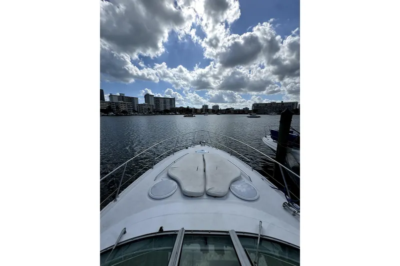 Slide: The Image of 2006 Four Winns 348 Vista boat on calm water, cityscape background. - 4