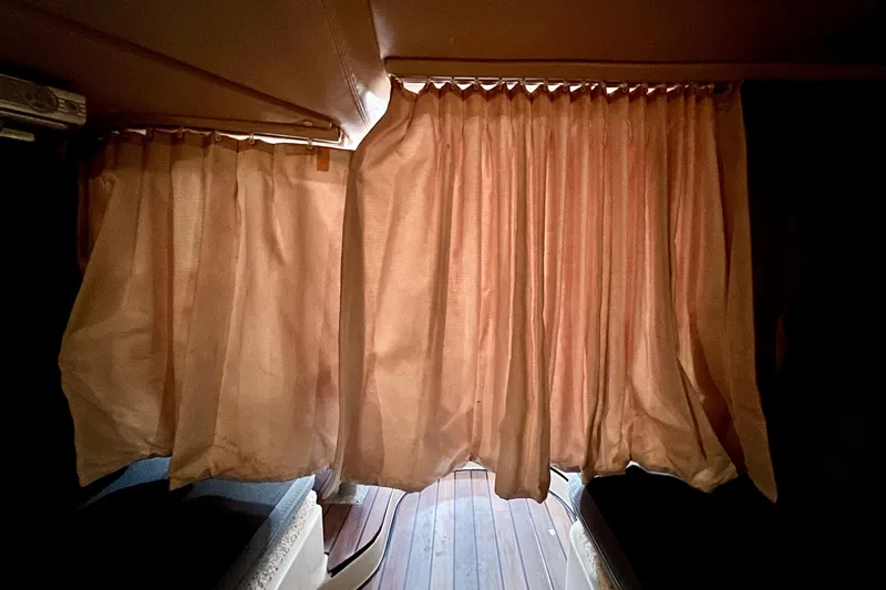 Slide: The Image of Interior view of 2006 Four Winns 348 Vista with closed beige curtains. - 43