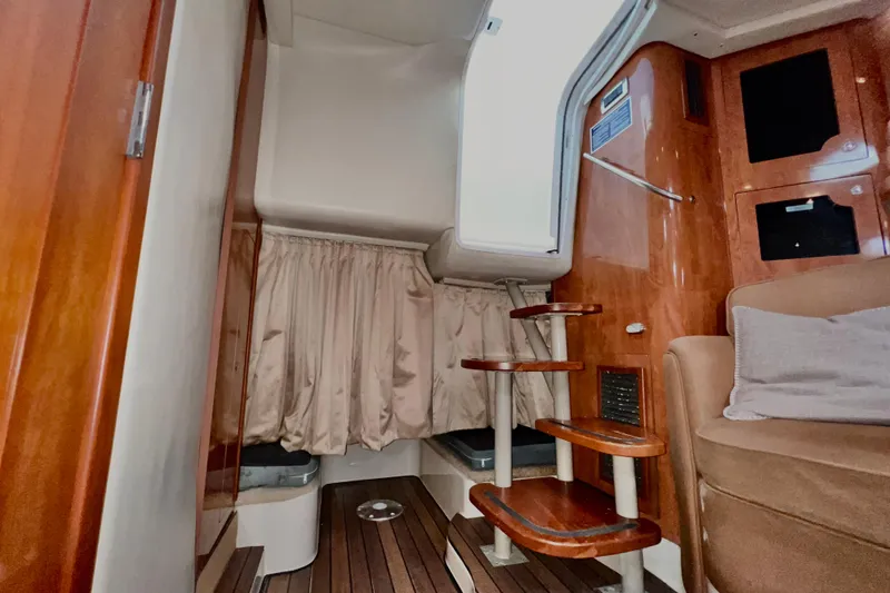 Slide: The Image of Interior of 2006 Four Winns 348 Vista yacht with wooden stairs and seating area. - 45