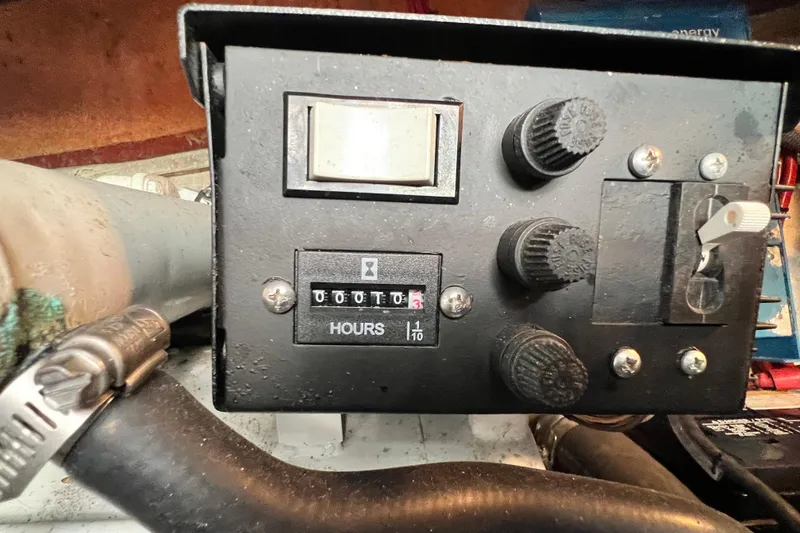 Slide: The Image of Control panel of a 2006 Four Winns 348 Vista boat, featuring hour meter and knobs. - 52