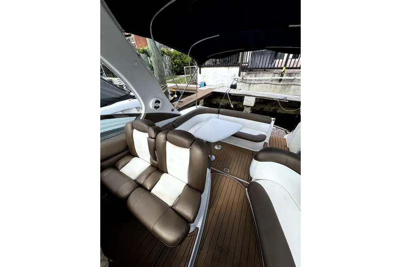 Slide: The Image of 2006 Four Winns 348 Vista yacht docked in a marina with cityscape background. - 6