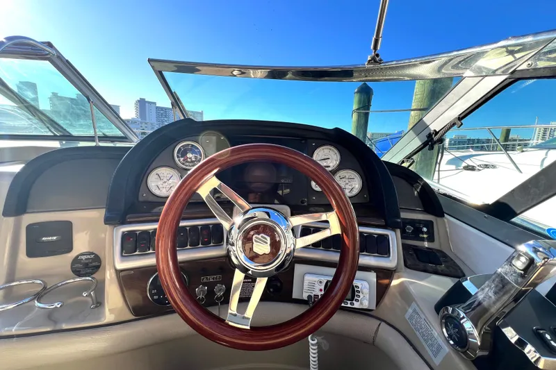 Slide: The Image of 2006 Four Winns 348 Vista boat dashboard with wooden steering wheel and gauges. - 60