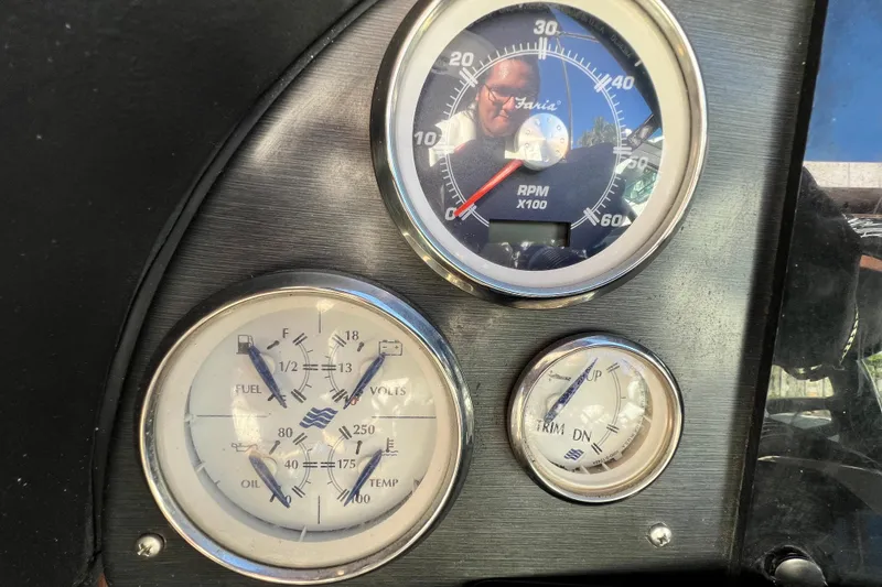 Slide: The Image of Dashboard gauges of a 2006 Four Winns 348 Vista boat, showing RPM, fuel, and trim levels. - 62