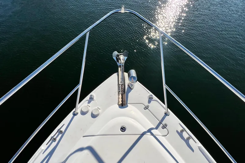 Slide: The Image of Bow view of 2006 Four Winns 348 Vista boat on water with sunlight reflections. - 64