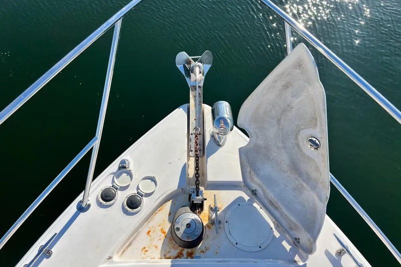 Slide: The Image of Bow of 2006 Four Winns 348 Vista boat with anchor and railing over water. - 65