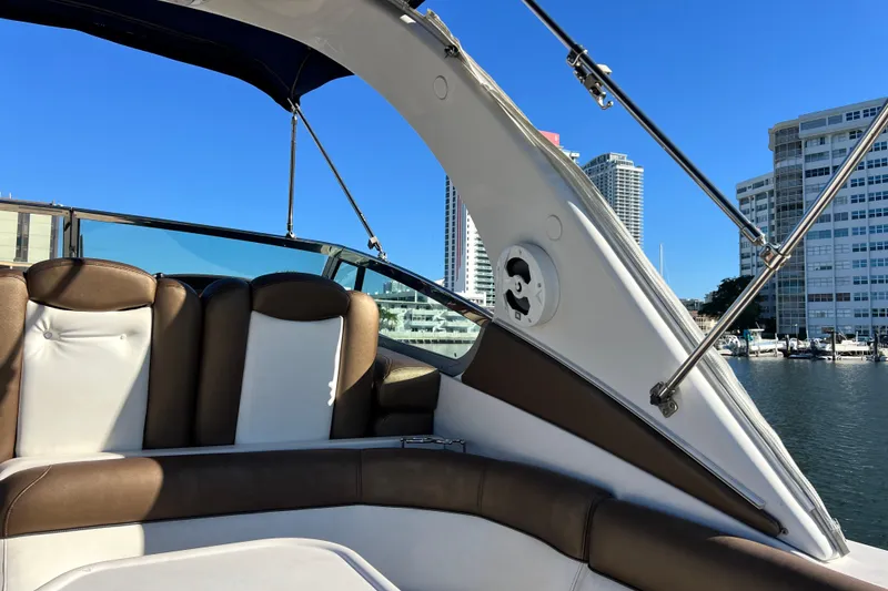 Slide: The Image of 2006 Four Winns 348 Vista boat interior with brown and white seating, cityscape background. - 74