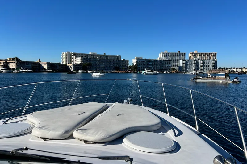 Slide: The Image of 2006 Four Winns 348 Vista yacht cruising in a sunny waterfront cityscape. - 90