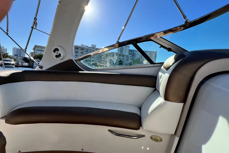 Slide: The Image of Interior view of 2006 Four Winns 348 Vista boat with cushioned seating and cityscape background. - 93