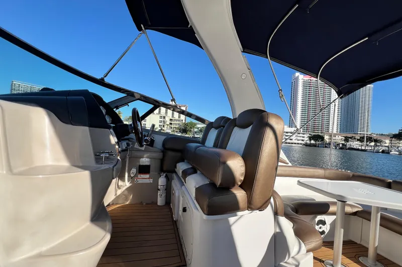 Slide: The Image of 2006 Four Winns 348 Vista boat interior with leather seating and marina view. - 94