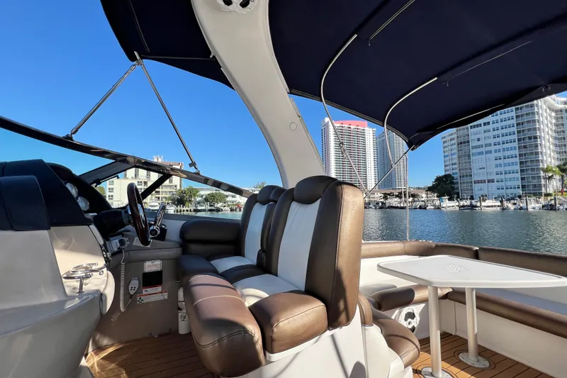 Slide: The Image of 2006 Four Winns 348 Vista boat interior with seating, table, and marina view. - 95
