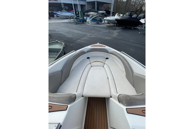 Slide: The Image of 2007 Yamaha Boats AR230 HO interior with cushioned seating and wood accents. - 6