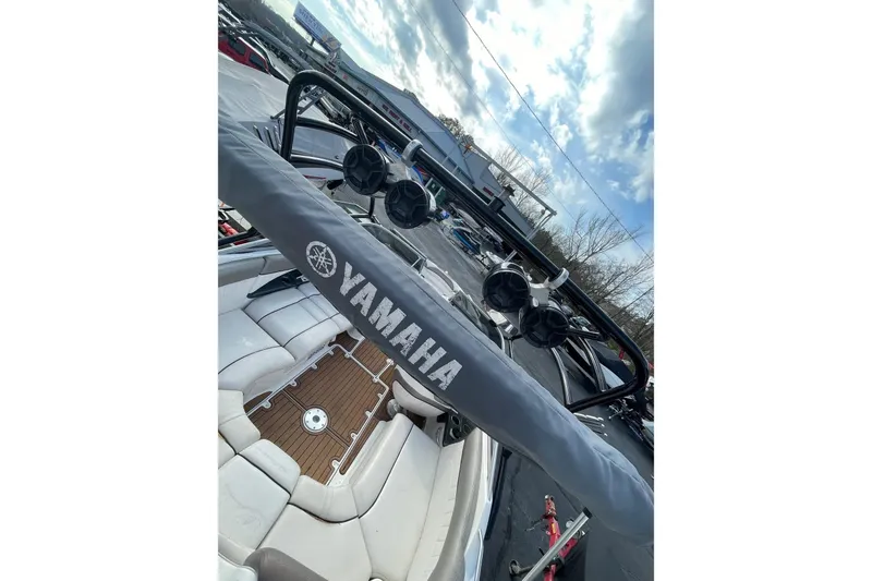 Slide: The Image of 2007 Yamaha Boats AR230 HO interior with speakers and seating, under a cloudy sky. - 8