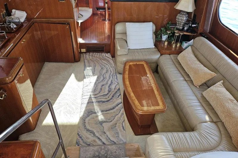 Slide: The Image of Luxurious 2003 Johnson FLY yacht interior with leather seating and elegant wood finishes. - 13