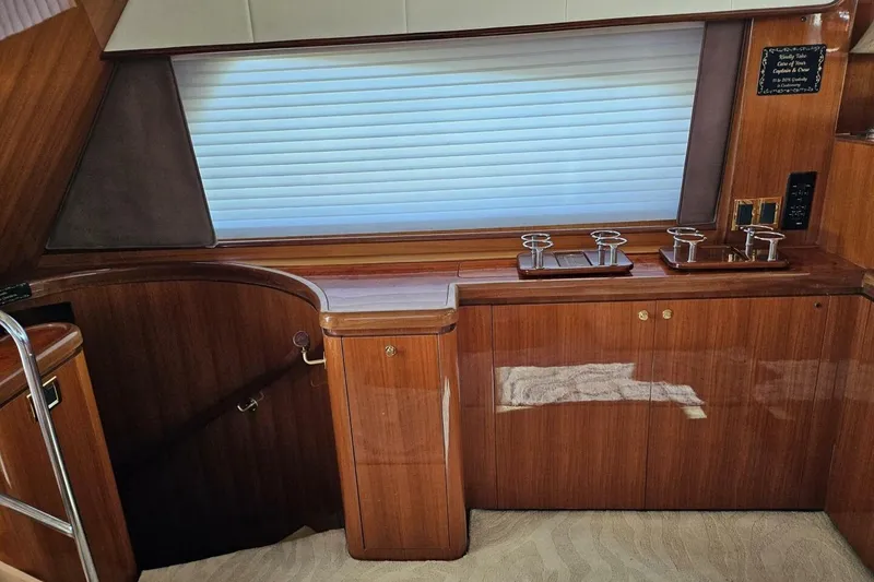 Slide: The Image of Luxurious wooden interior of a 2003 Johnson FLY yacht with elegant cabinetry and fixtures. - 15