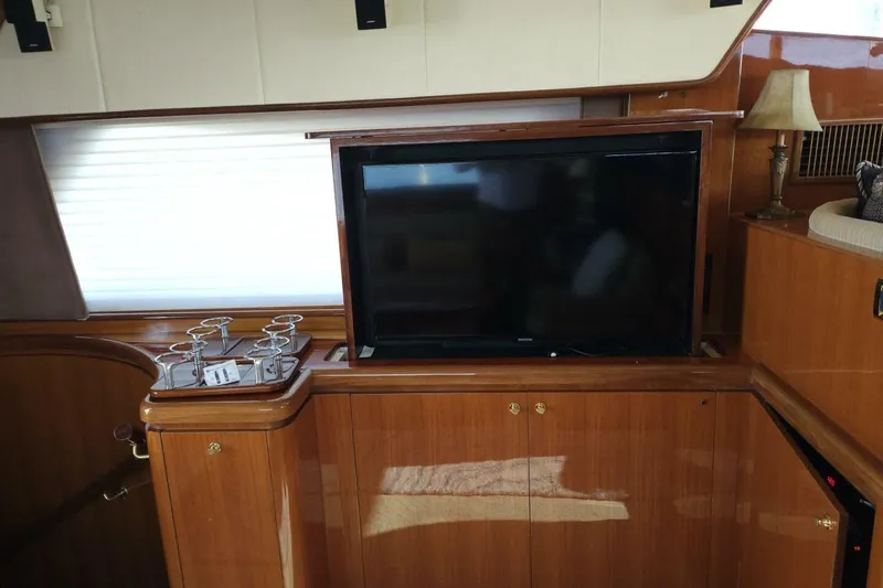 Slide: The Image of Luxurious interior of 2003 Johnson FLY yacht with TV and elegant wood finish. - 16