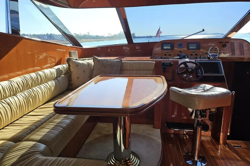 Slide: The Image of Luxurious 2003 Johnson FLY yacht interior with plush seating and polished wood finishes. - 18
