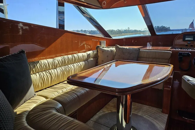 Slide: The Image of Luxurious 2003 Johnson FLY yacht interior with plush seating and polished wood table. - 19